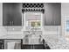Kitchen with stainless steel sink and appliances, granite countertops, dark cabinetry, and wine rack at 2865 Winter Rose Ct, Dunwoody, GA 30360
