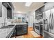 Modern kitchen features stainless steel appliances, granite countertops, tile backsplash, and wood floors at 2865 Winter Rose Ct, Dunwoody, GA 30360