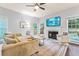 Comfortable living room with fireplace, large windows providing ample light, and sleek hardwood floors at 2865 Winter Rose Ct, Dunwoody, GA 30360