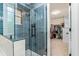 Modern shower with blue tiling and glass enclosure, adjacent to a walk-in closet at 2865 Winter Rose Ct, Dunwoody, GA 30360