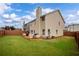 Spacious backyard with a wooden deck, well-kept lawn, and privacy fence, perfect for outdoor activities at 4015 Arch Pass, Cumming, GA 30040