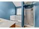 Modern bathroom featuring a large tub, shower, tile floors, and sky blue paint at 4015 Arch Pass, Cumming, GA 30040