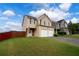 Inviting two-story home with a two-car garage, well-maintained lawn, and a spacious driveway at 4015 Arch Pass, Cumming, GA 30040