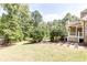 Manicured backyard and patio with beautiful landscaping and a covered porch at 4090 Cooks Farm Nw Dr, Kennesaw, GA 30152