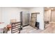 Unfinished basement area with a refrigerator, boxes, chairs, and a barn door at 4090 Cooks Farm Nw Dr, Kennesaw, GA 30152