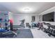 Basement gym features a treadmill, weight rack and TV making it a great place to work out at 4090 Cooks Farm Nw Dr, Kennesaw, GA 30152