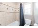 This bathroom features tile surround walls, a tub/shower combo and a window for natural light at 4090 Cooks Farm Nw Dr, Kennesaw, GA 30152