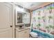 Bright bathroom with granite countertops, framed mirror, and a fun palm tree shower curtain at 4090 Cooks Farm Nw Dr, Kennesaw, GA 30152
