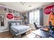 This bedroom boasts unique wall decor, a comfortable bed and a spacious desk area at 4090 Cooks Farm Nw Dr, Kennesaw, GA 30152