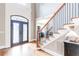 Grand foyer featuring hardwood floors, a wrought iron staircase, and a decorative front door at 4090 Cooks Farm Nw Dr, Kennesaw, GA 30152