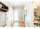 Hallway with hardwood floors leading to pantry and exterior door at 4090 Cooks Farm Nw Dr, Kennesaw, GA 30152
