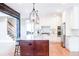 Well-lit kitchen with stainless steel appliances, granite countertops, white cabinets, and wood floors at 4090 Cooks Farm Nw Dr, Kennesaw, GA 30152