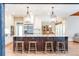 Spacious kitchen featuring island with granite countertops, pendant lights, stainless steel fridge, and hardwood floors at 4090 Cooks Farm Nw Dr, Kennesaw, GA 30152