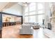 Bright living room featuring hardwood floors, a fireplace, and large windows at 4090 Cooks Farm Nw Dr, Kennesaw, GA 30152