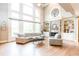 Sunlit living room with hardwood floors, fireplace, and large windows overlooking the backyard at 4090 Cooks Farm Nw Dr, Kennesaw, GA 30152