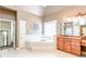 Relaxing main bathroom features a soaking tub, tiled shower, dual sinks, and lots of vanity storage at 4090 Cooks Farm Nw Dr, Kennesaw, GA 30152