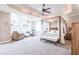 Spacious main bedroom with sitting area, fireplace, sitting bench, ceiling fan, and chandelier at 4090 Cooks Farm Nw Dr, Kennesaw, GA 30152