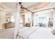 Luxury main bedroom showcasing a canopy bed, sitting area, fireplace, and natural lighting at 4090 Cooks Farm Nw Dr, Kennesaw, GA 30152