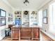 Home office with custom built-in bookshelves, hardwood floors, and a large executive desk at 4090 Cooks Farm Nw Dr, Kennesaw, GA 30152