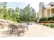 Spacious outdoor patio and dining area with stone retaining wall and large backyard at 4090 Cooks Farm Nw Dr, Kennesaw, GA 30152