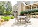 Spacious outdoor patio and dining area with lush landscaping and a large backyard at 4090 Cooks Farm Nw Dr, Kennesaw, GA 30152