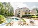 Backyard features a pool, hot tub, lush landscaping, and an outdoor seating area at 4090 Cooks Farm Nw Dr, Kennesaw, GA 30152