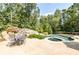 Backyard features a pool, hot tub, patio, and an outdoor dining set perfect for entertaining at 4090 Cooks Farm Nw Dr, Kennesaw, GA 30152