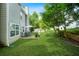 Spacious backyard with a patio, seating area, and lush green lawn at 4125 Fallbrook Dr, Duluth, GA 30096