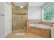 Modern bathroom featuring a glass-enclosed shower, a luxurious soaking tub, and travertine tile accents at 4125 Fallbrook Dr, Duluth, GA 30096