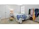 Cozy bedroom with carpet floors and a clothing rack at 4125 Fallbrook Dr, Duluth, GA 30096