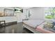 Bright bedroom with hardwood floors, neutral walls, and a dresser with mirror at 4125 Fallbrook Dr, Duluth, GA 30096