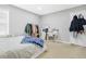 Serene bedroom with a comfy bed, neutral carpet, and stylish clothing rack, complemented by natural light at 4125 Fallbrook Dr, Duluth, GA 30096