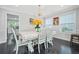Bright dining room with modern lighting and table with seating next to a breakfast area at 4125 Fallbrook Dr, Duluth, GA 30096