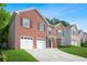 Attractive brick home with a well-maintained lawn, double garage, and inviting entrance in a residential area at 4125 Fallbrook Dr, Duluth, GA 30096