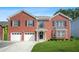 Charming two-story brick home with well-manicured lawn and a two-car garage in a suburban neighborhood at 4125 Fallbrook Dr, Duluth, GA 30096