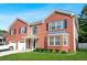 Two-story red brick home with an attached garage and a neatly kept front yard at 4125 Fallbrook Dr, Duluth, GA 30096