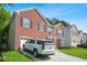 Two-story red brick home with an attached garage, and a neatly kept lawn at 4125 Fallbrook Dr, Duluth, GA 30096