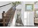 Hallway featuring hardwood floors, iron railing and a staircase leading to the upper level at 4125 Fallbrook Dr, Duluth, GA 30096