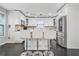 Modern kitchen features white cabinets, stainless steel appliances, and a granite countertop island with seating at 4125 Fallbrook Dr, Duluth, GA 30096