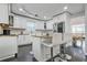 Bright kitchen features white cabinets, stainless steel appliances, granite countertops, and island seating at 4125 Fallbrook Dr, Duluth, GA 30096