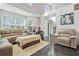 Bright living room with comfortable seating, hardwood floors, and a large arched window at 4125 Fallbrook Dr, Duluth, GA 30096