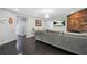Cozy living room with hardwood floors, a stone fireplace, and a comfortable grey sectional sofa at 4125 Fallbrook Dr, Duluth, GA 30096