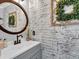 Charming bathroom featuring a decorative brick wall, vanity, and stylish accents at 5625 Brookstone Nw Dr, Acworth, GA 30101