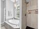 Bright bathroom with a soaking tub under a window and a tiled shower with a built-in niche at 5625 Brookstone Nw Dr, Acworth, GA 30101