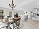 Open dining area with stylish chandelier and access to kitchen and outdoor deck at 5625 Brookstone Nw Dr, Acworth, GA 30101