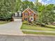 Charming brick home with a well-manicured lawn, mature trees and attached two car garage at 5625 Brookstone Nw Dr, Acworth, GA 30101
