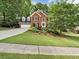 Beautiful brick home featuring a well-manicured front lawn and mature landscaping at 5625 Brookstone Nw Dr, Acworth, GA 30101