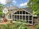 Back of home, showcasing the screened in porch, brick patio, deck and beautiful landscaping at 5625 Brookstone Nw Dr, Acworth, GA 30101