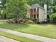 Well-maintained lawn and landscaping showcasing a beautiful brick home at 5625 Brookstone Nw Dr, Acworth, GA 30101