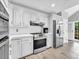 Well-lit kitchen features white cabinetry, stainless steel appliances, and a modern backsplash at 5625 Brookstone Nw Dr, Acworth, GA 30101
